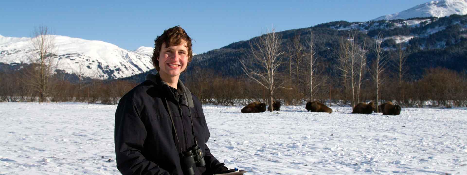 UAF student Luke Rogers studying bison